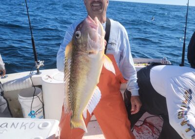 a person holding a fish on a boat